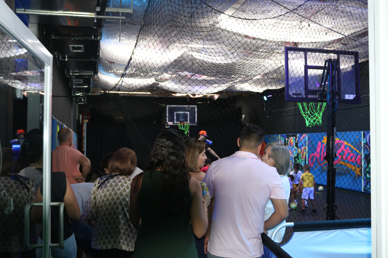 Spectators watching from the basketball court at All Star Party World