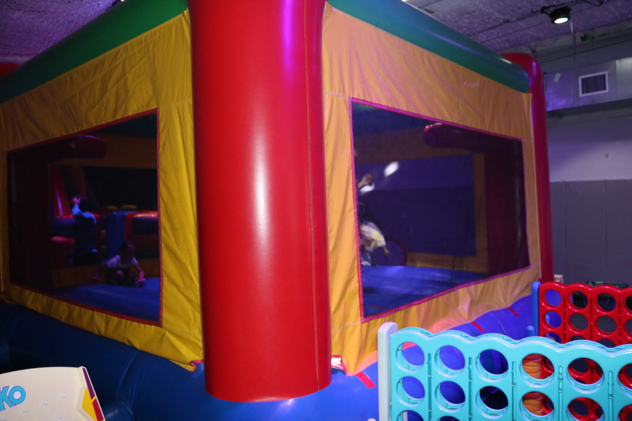 Bounce house exterior with Connect Four game at All Star Party World