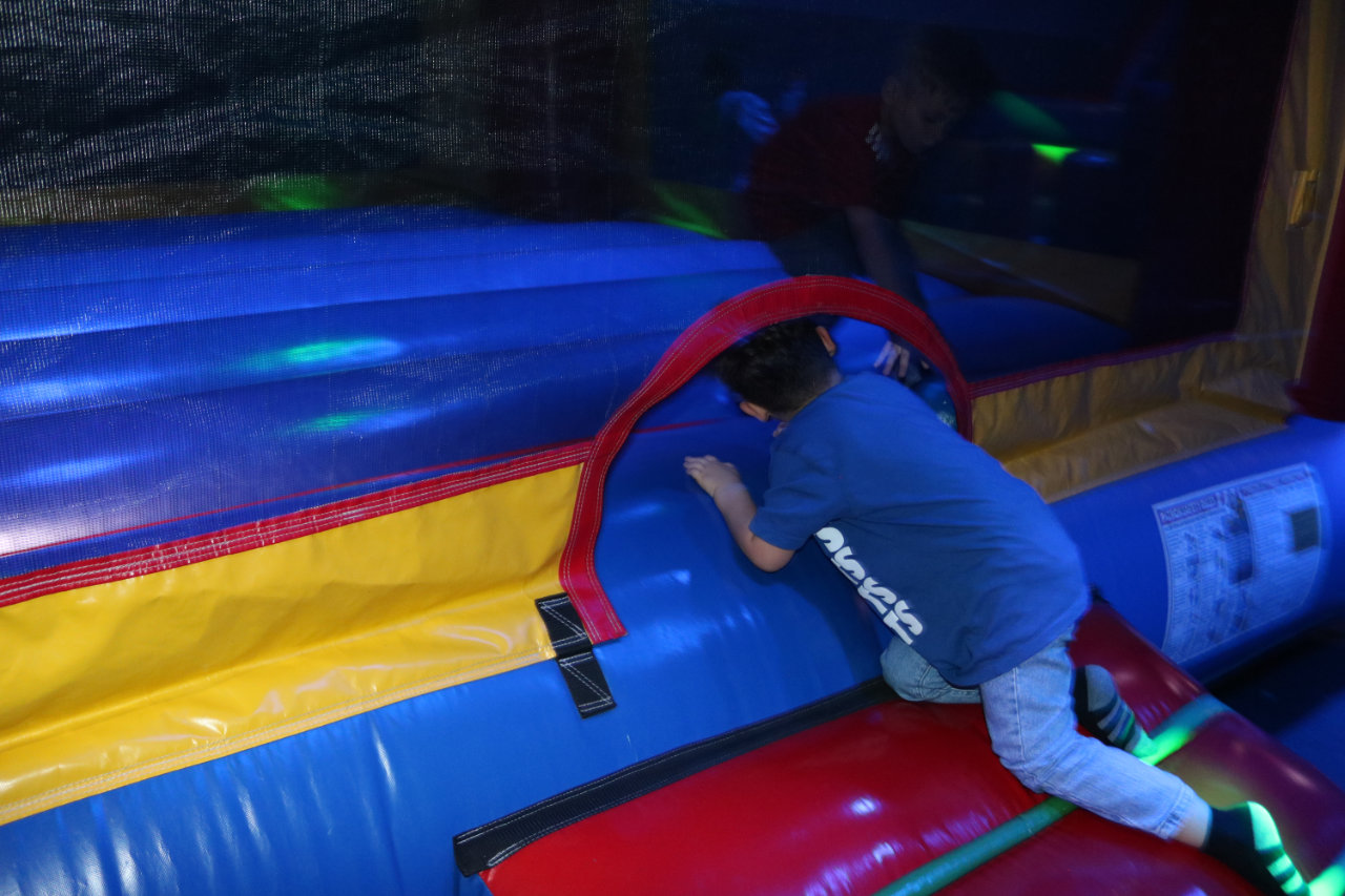 Boy climbing into the bounce house entrance at All Star Party World