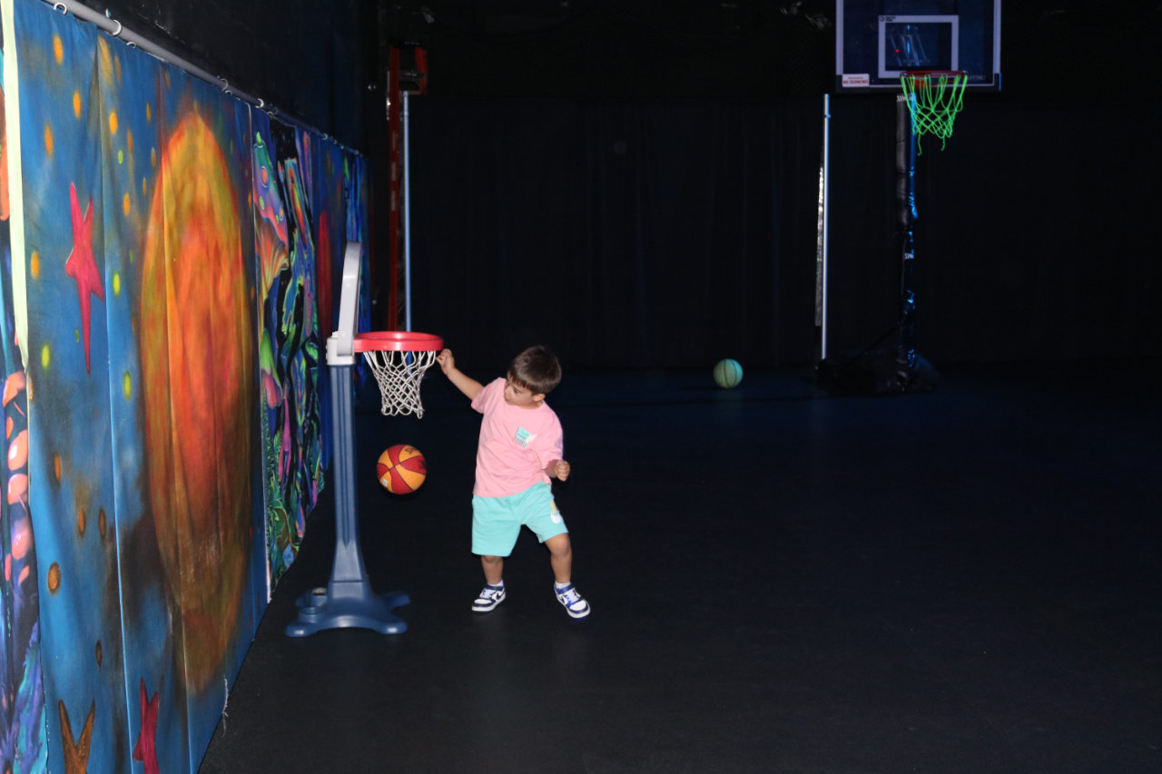 Child shooting at a mini basketball hoop at All Star Party World