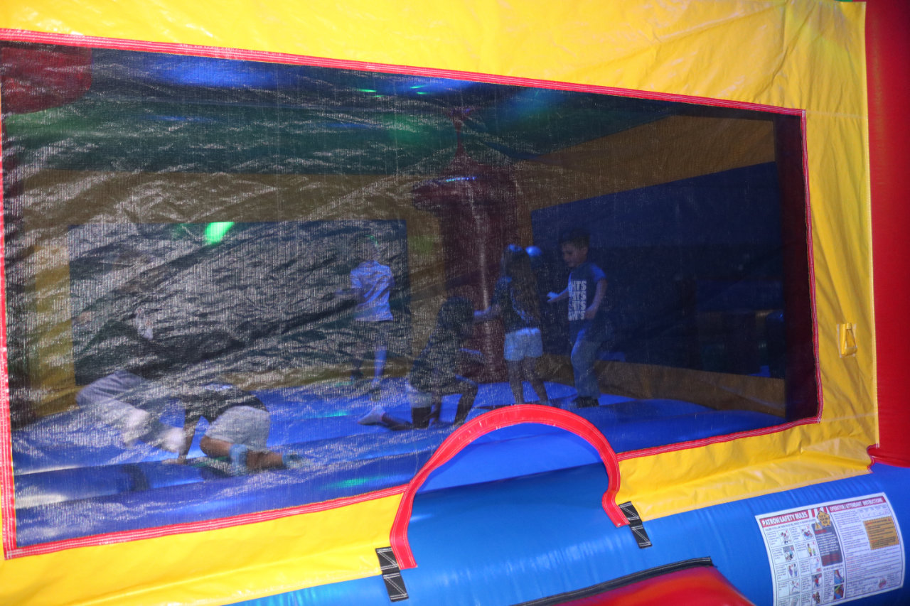Child inside the bounce house net at All Star Party World