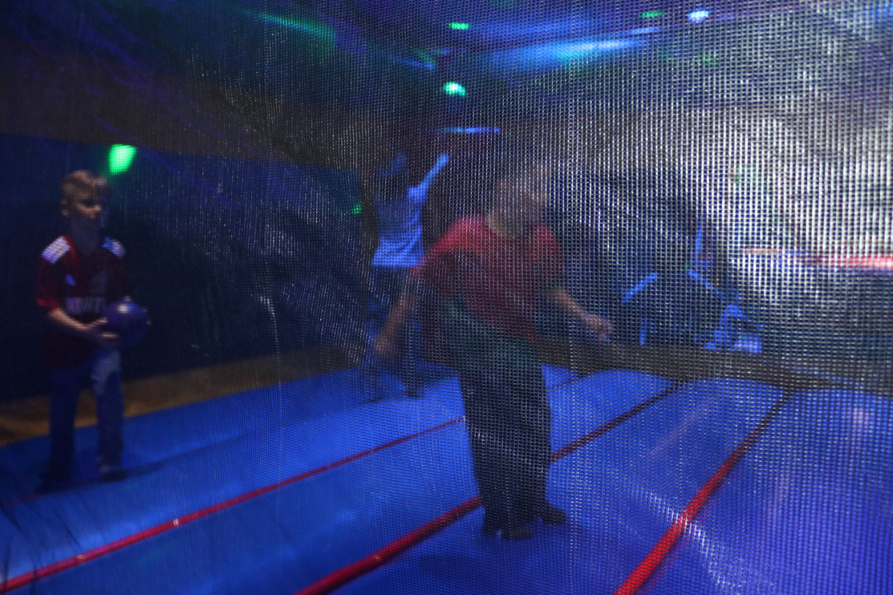 Child inside the bounce house netting at All Star Party World