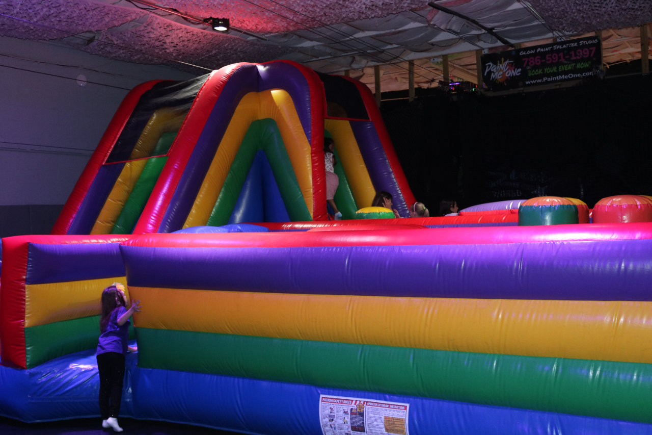 Child near the inflatable obstacle course at All Star Party World