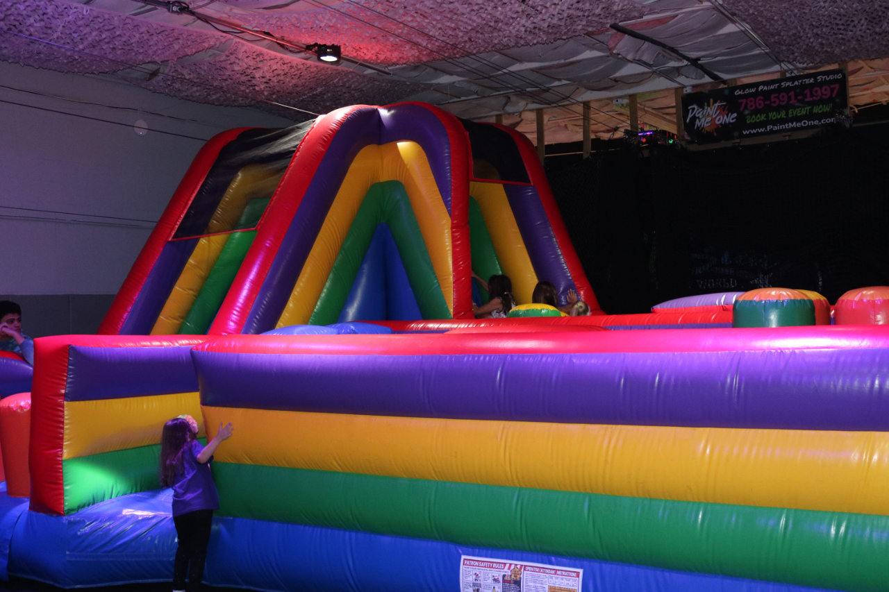 Child outside the inflatable obstacle course at All Star Party World