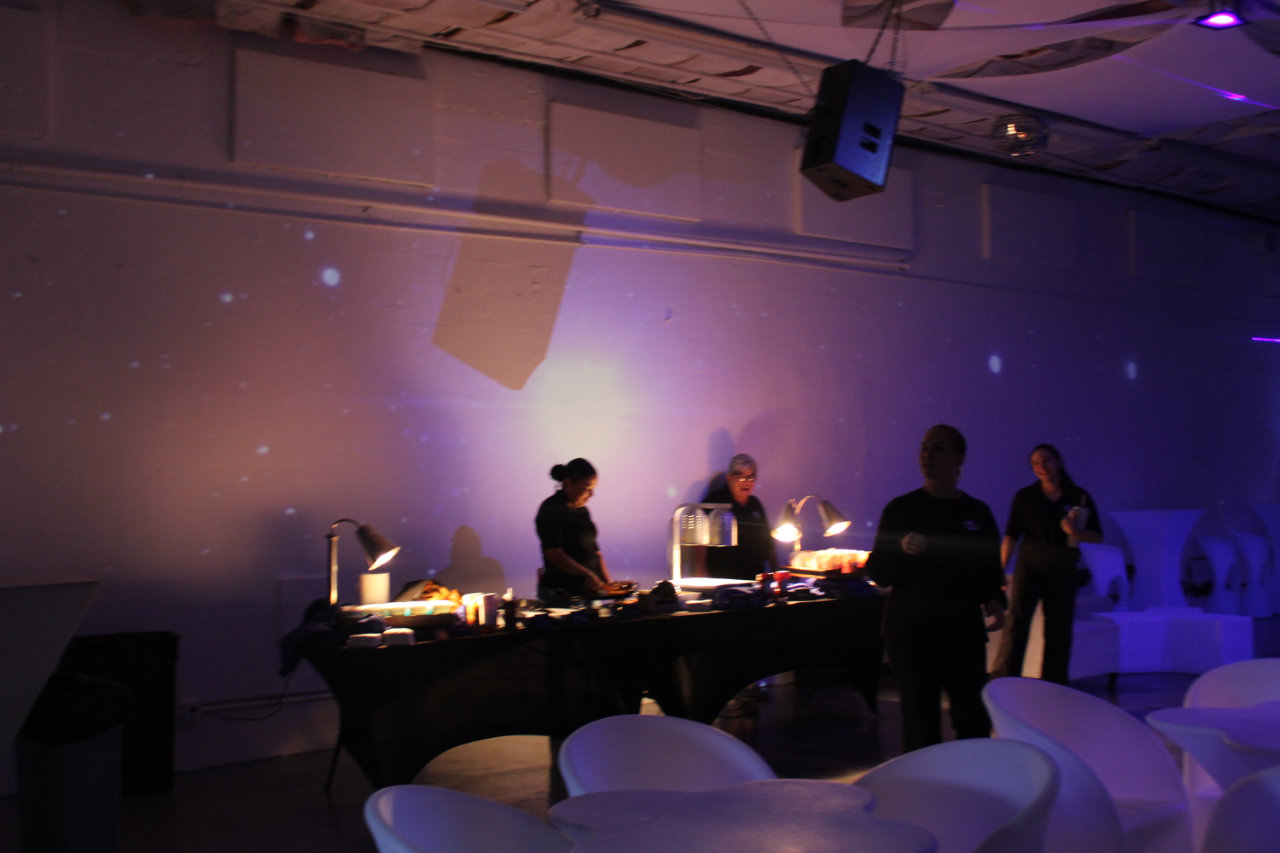 DJ on the dance floor with purple lights at All Star Party World