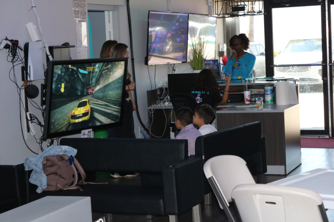 Family at the VR racing station at All Star Party World