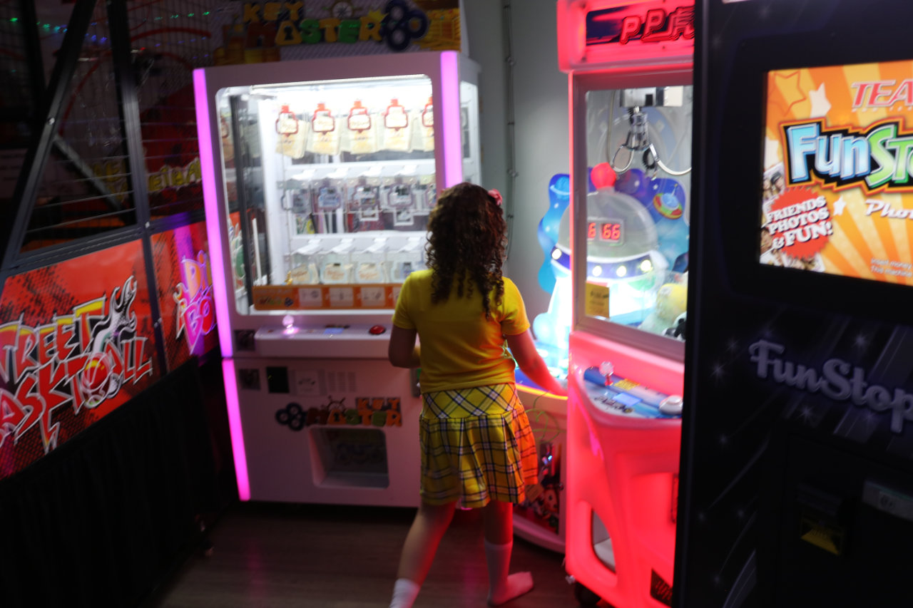 Girl playing arcade prize games at All Star Party World