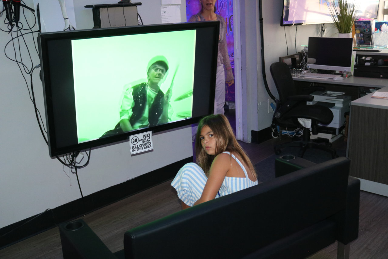 Girl watching a video game screen at All Star Party World