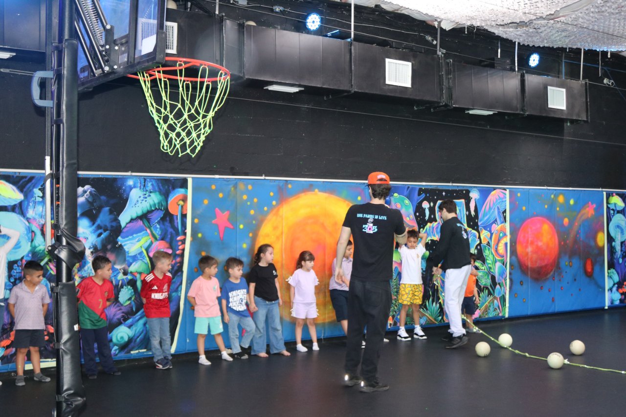 Group photo on the basketball court at All Star Party World