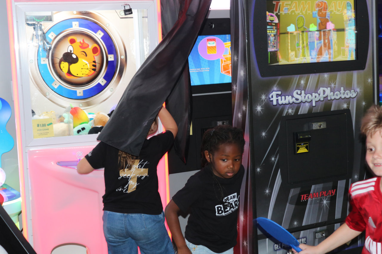 Kids playing the claw game in the arcade at All Star Party World