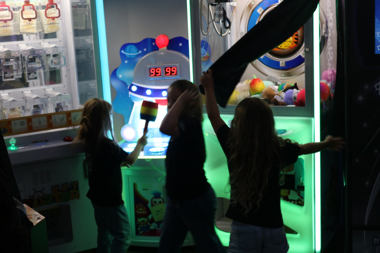 Kids at the arcade prize machine at All Star Party World