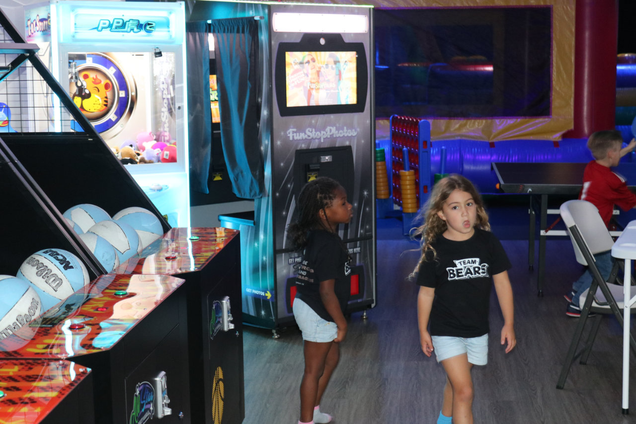 Kids in the arcade aisle at All Star Party World