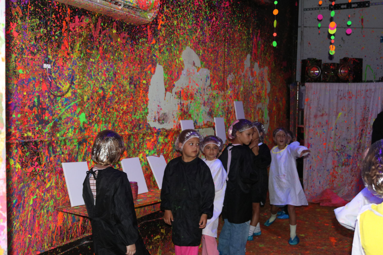Group of kids in the paint splatter room at All Star Party World