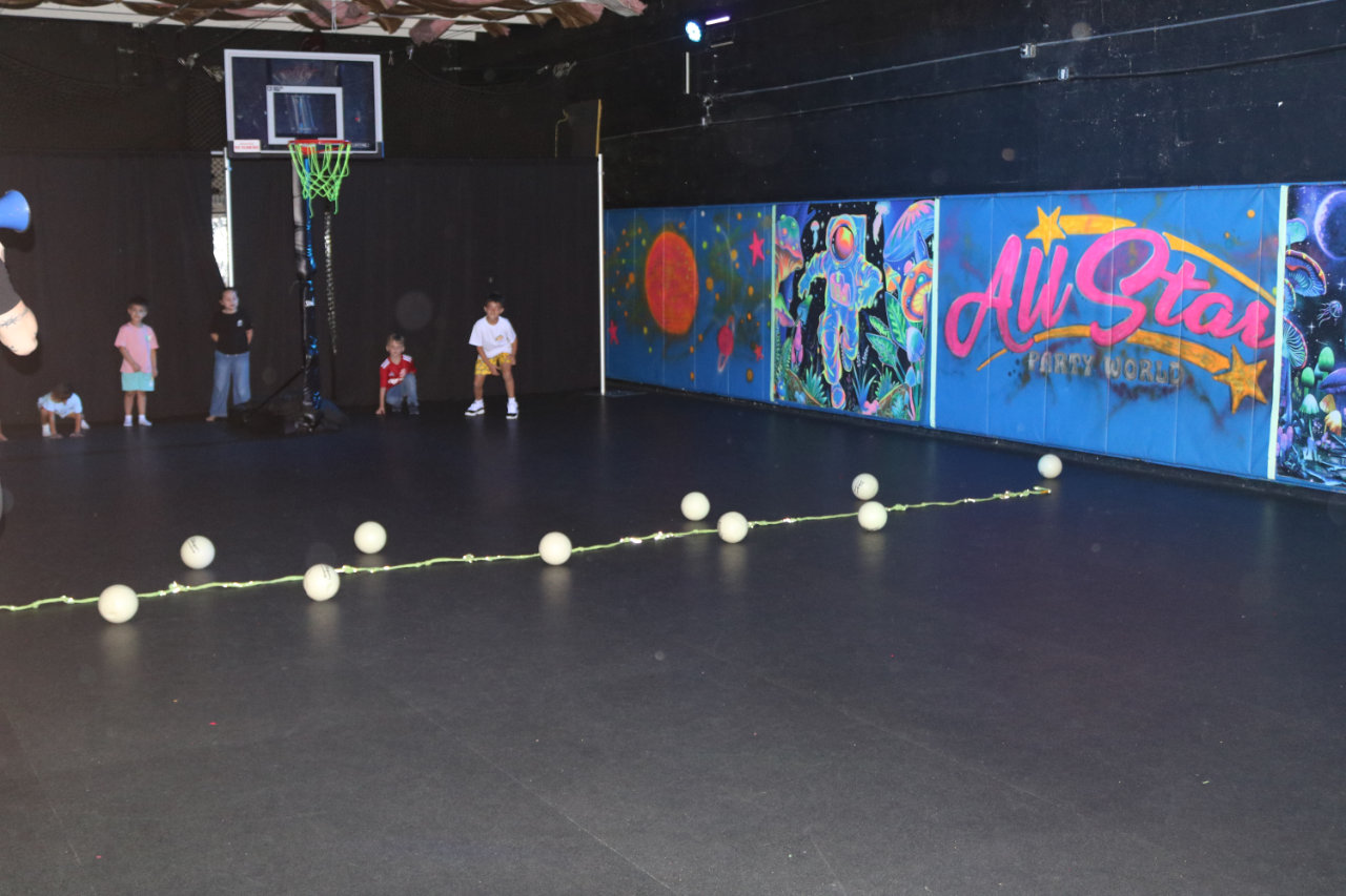 Kids lined up on the basketball court at All Star Party World
