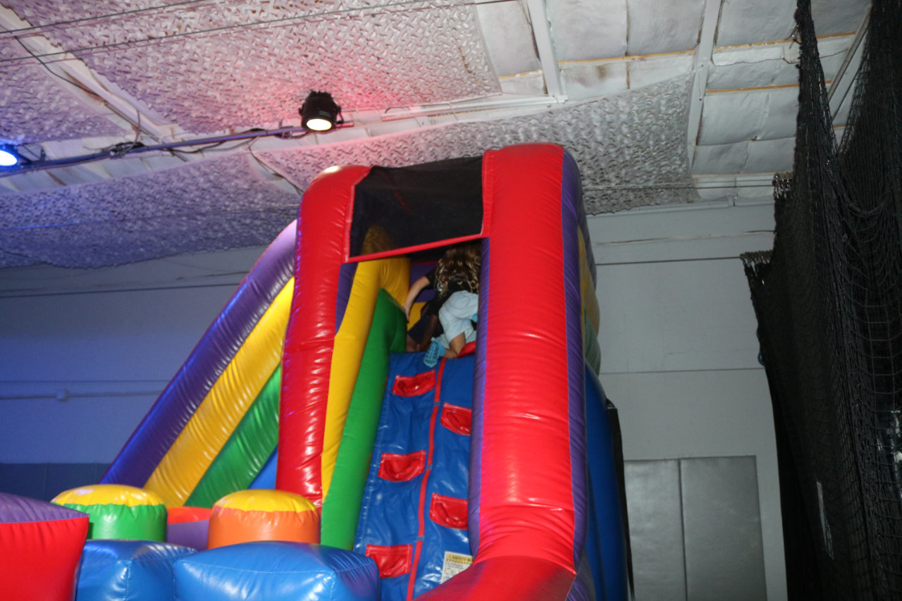 Kids on the inflatable slide at All Star Party World
