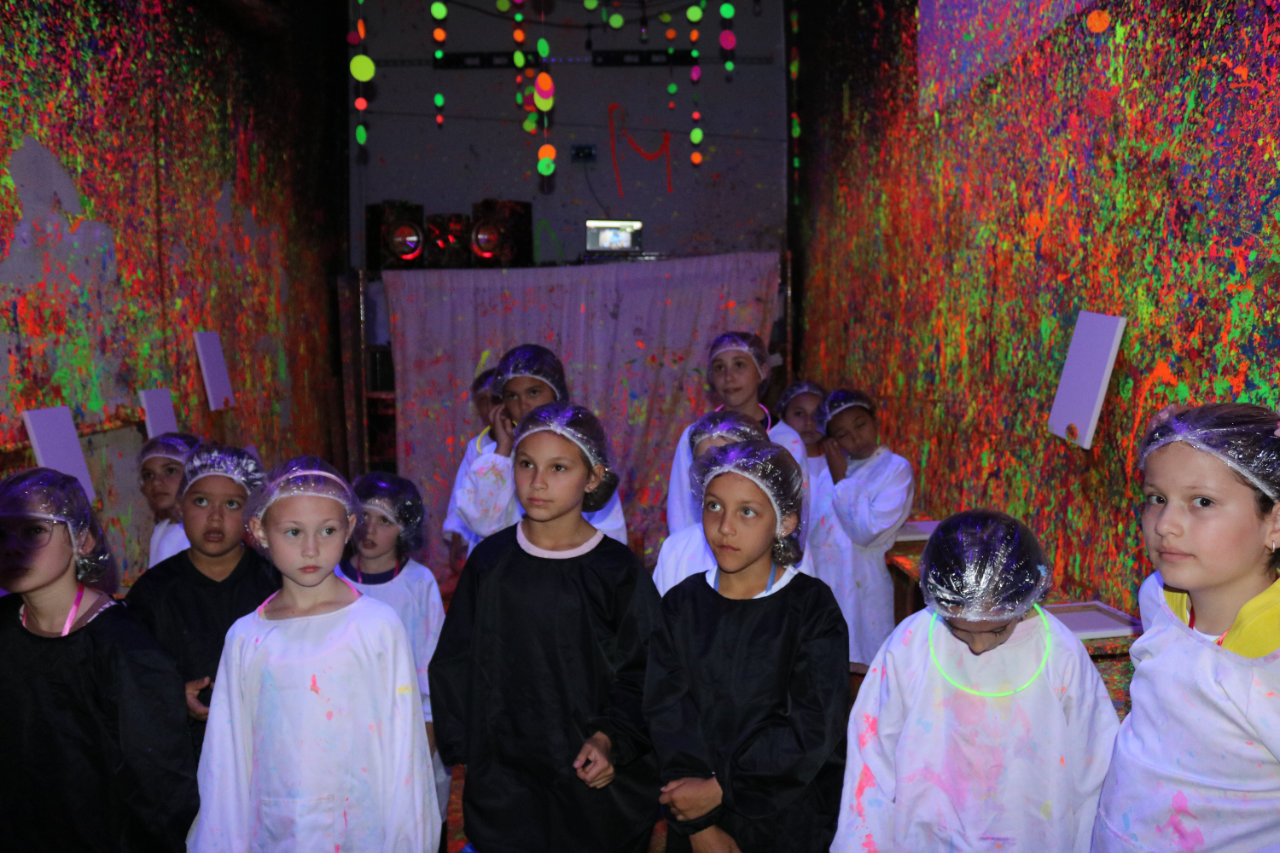 Portrait of kids in the paint splatter room at All Star Party World