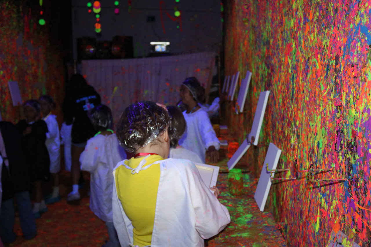 Kids painting canvases in the art room at All Star Party World