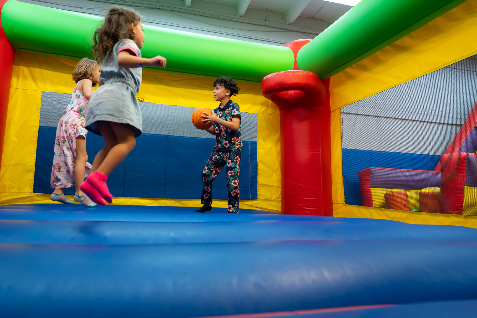 Kids playing bounce house basketball at All Star Party World