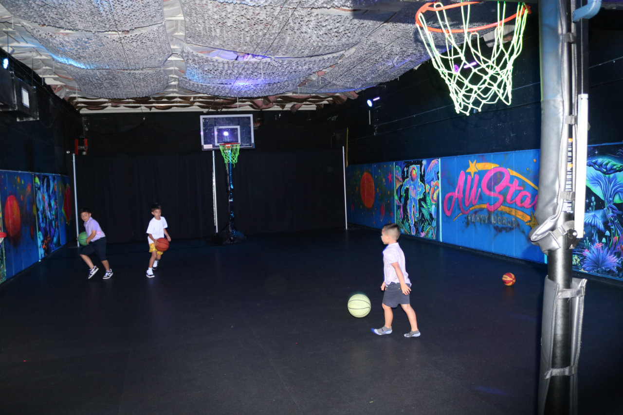 Kids playing on the basketball court at All Star Party World
