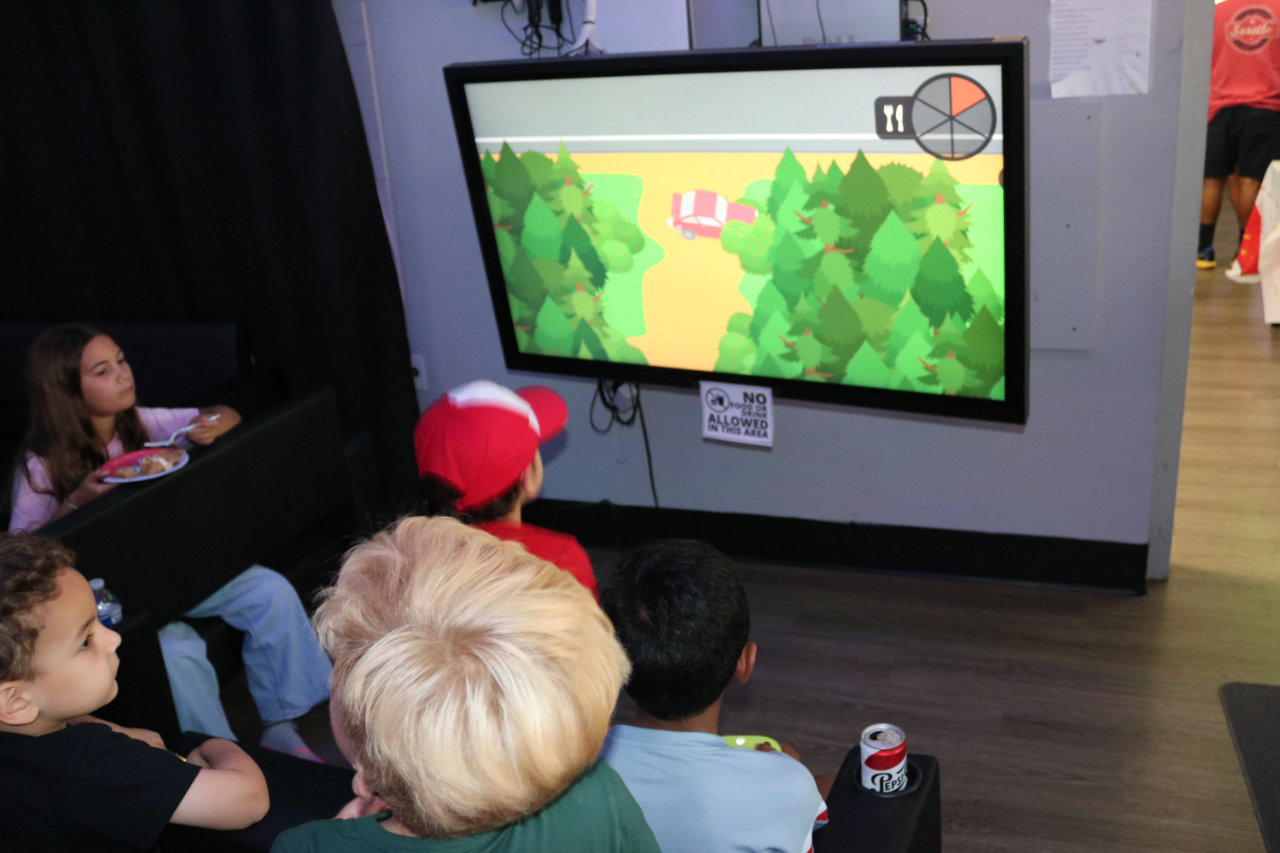 Kids seated watching the karaoke screen at All Star Party World