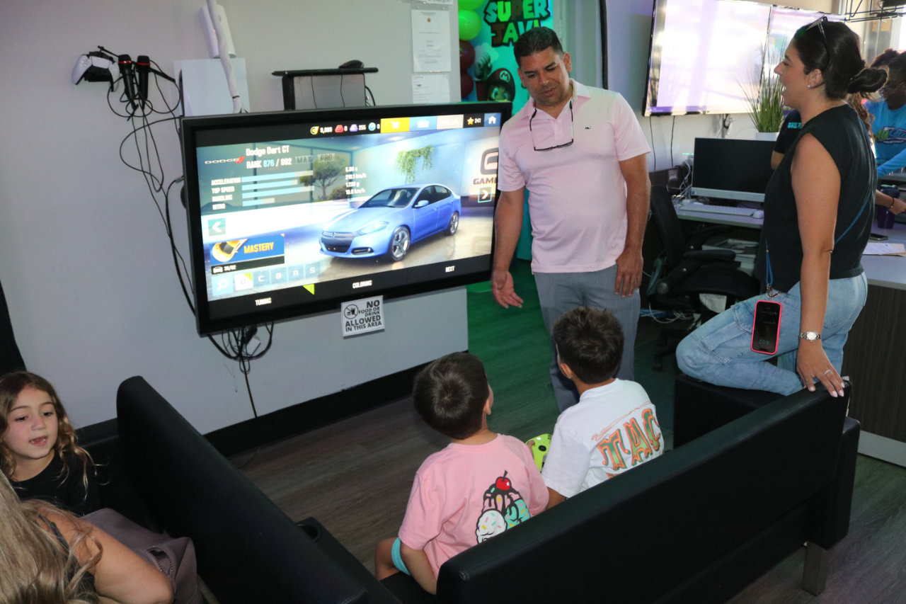 Kids watching a racing video game at All Star Party World