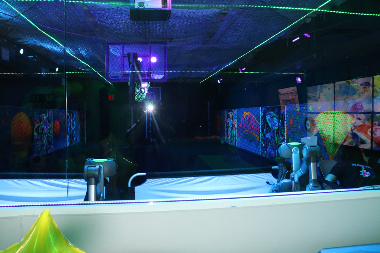 Basketball court lit with laser lights at All Star Party World