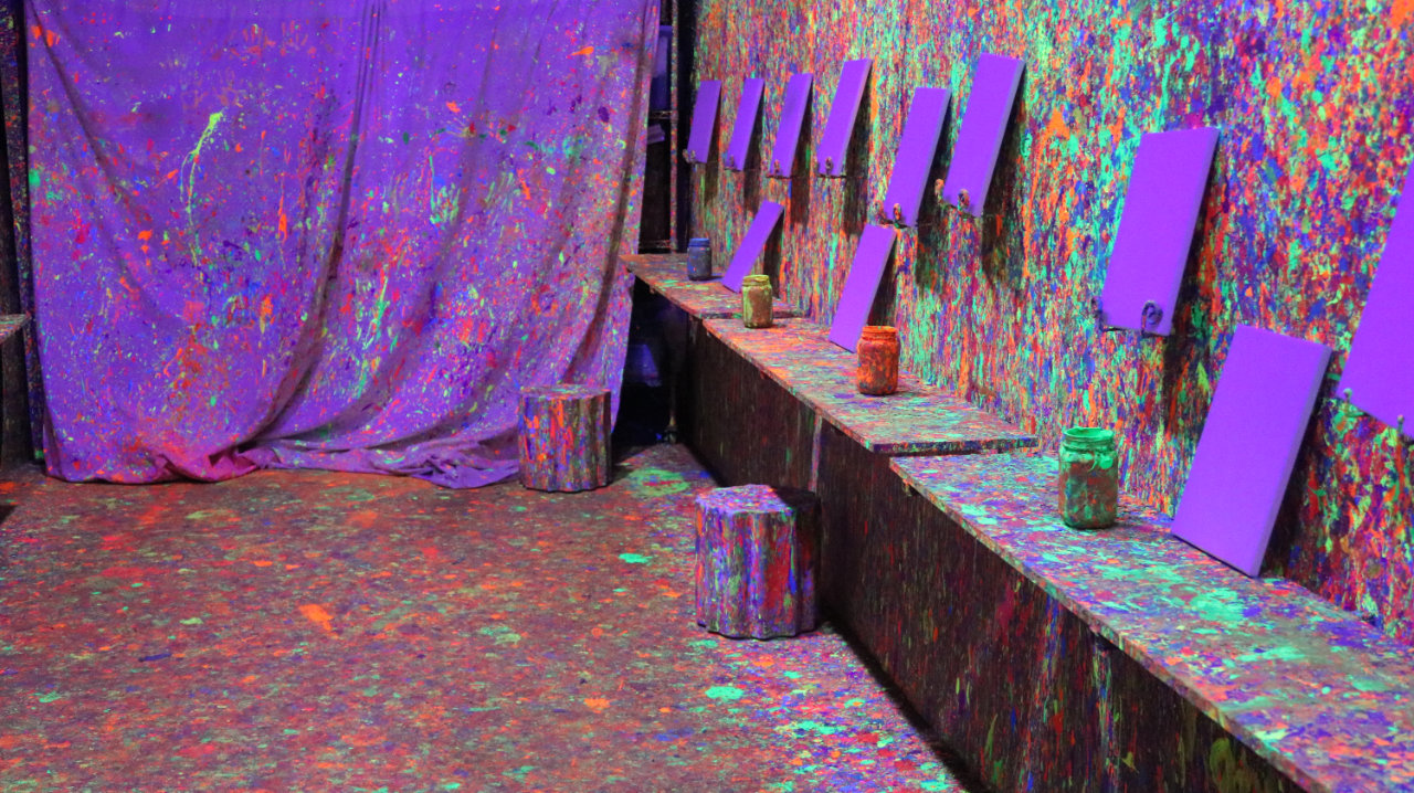 Close-up of canvases in the paint splatter room at All Star Party World