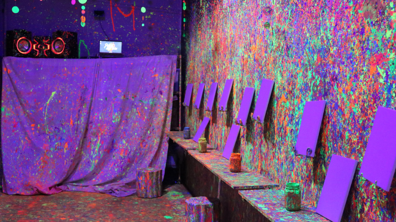 Paint splatter room with canvases set up at All Star Party World