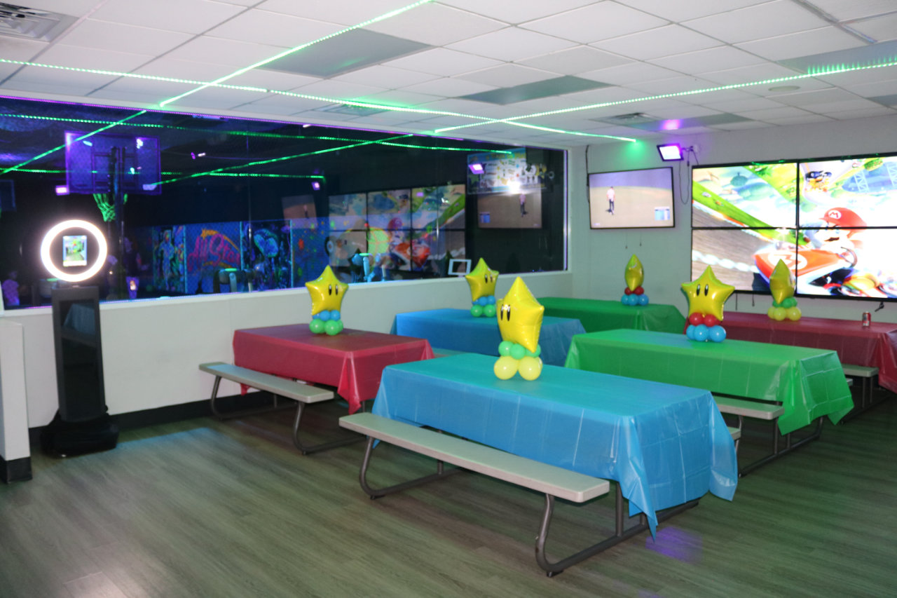 Party tables set up in the arcade room at All Star Party World