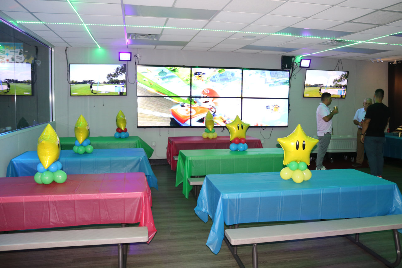 Party tables with TV screens at All Star Party World