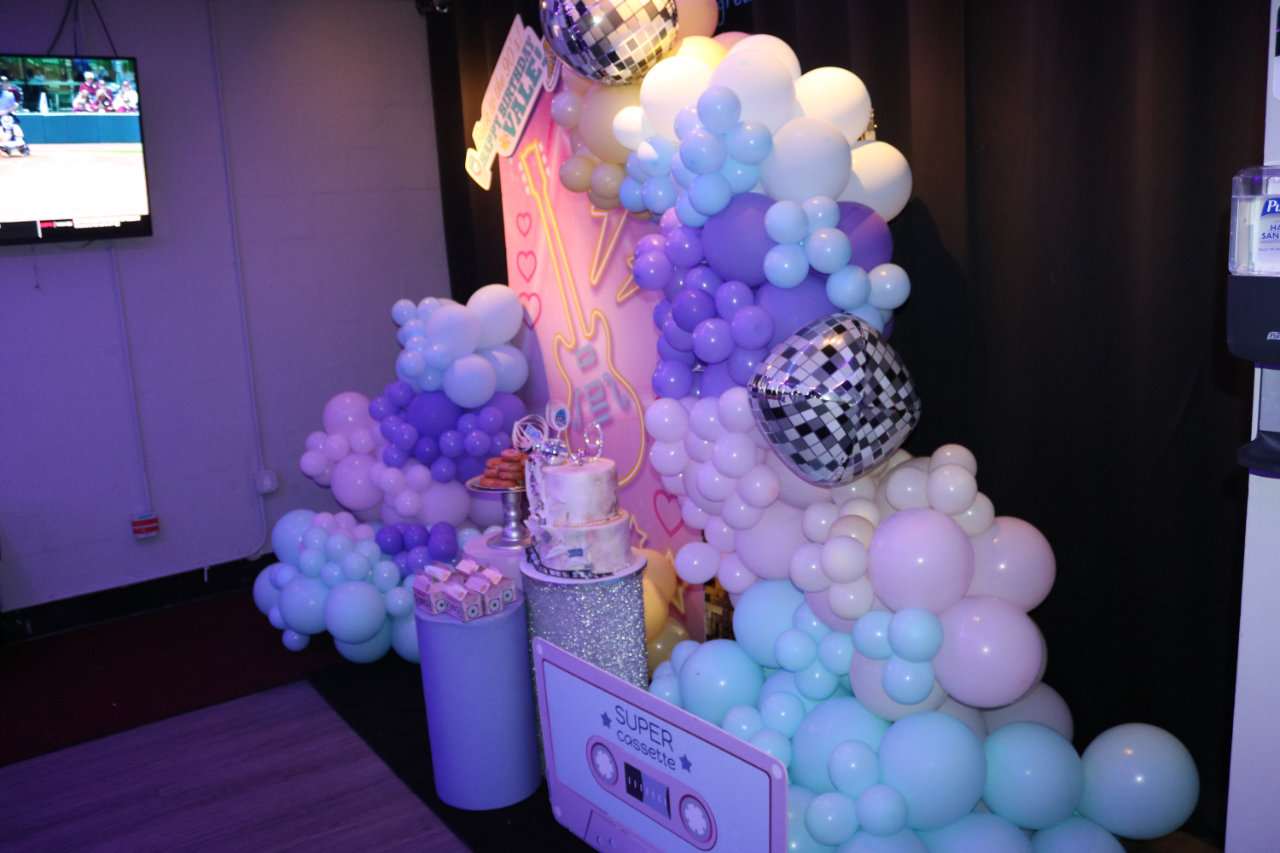 Pastel balloon and dessert cart setup at All Star Party World