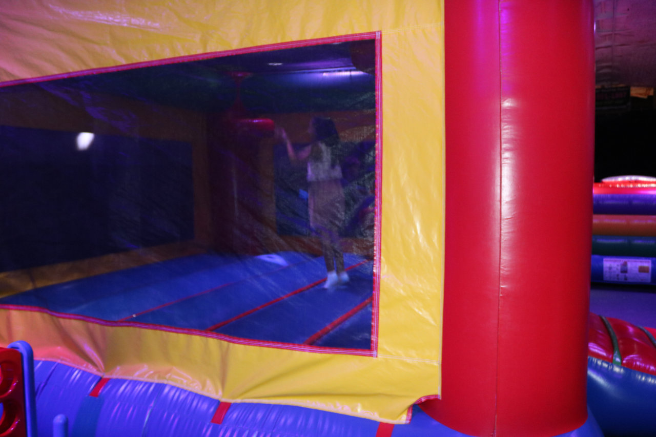 People visible through the bounce house window at All Star Party World