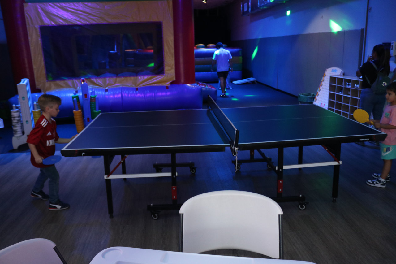 Ping pong tables and bounce room at All Star Party World