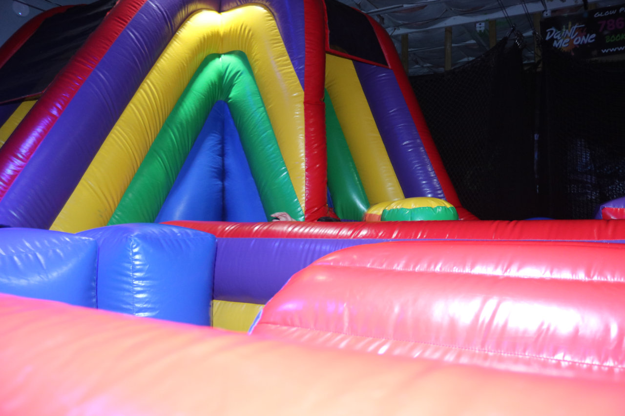 Rainbow colored inflatable obstacle course at All Star Party World