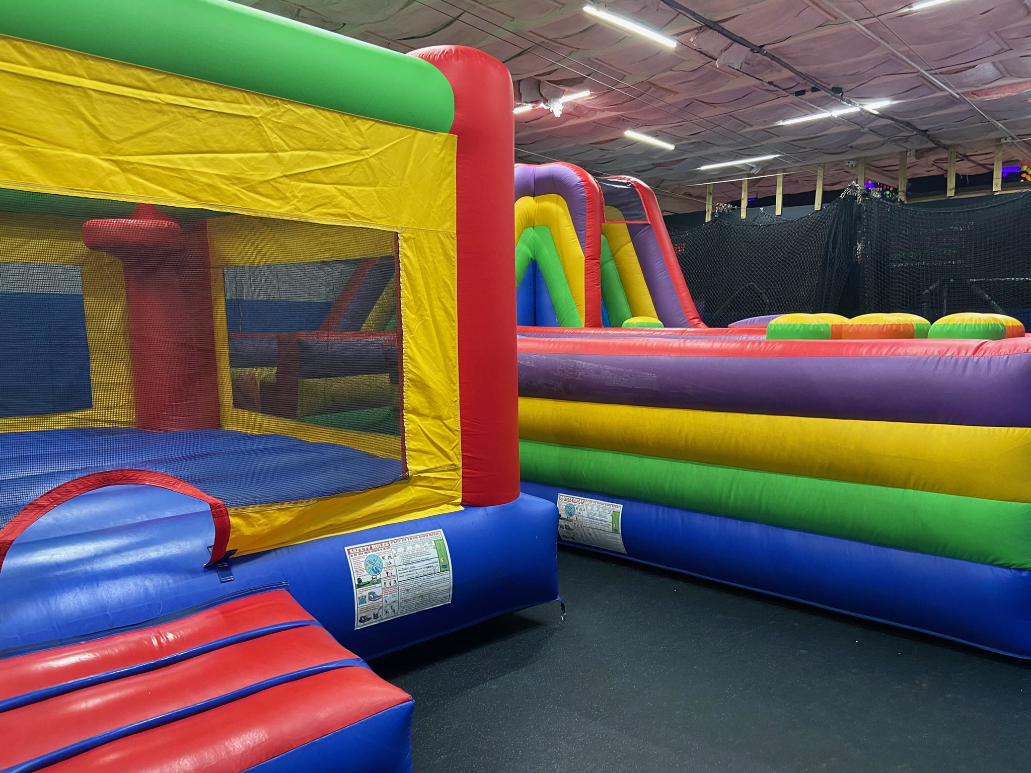 Inflatable bounce house and obstacle course set up in the All Star Party World venue
