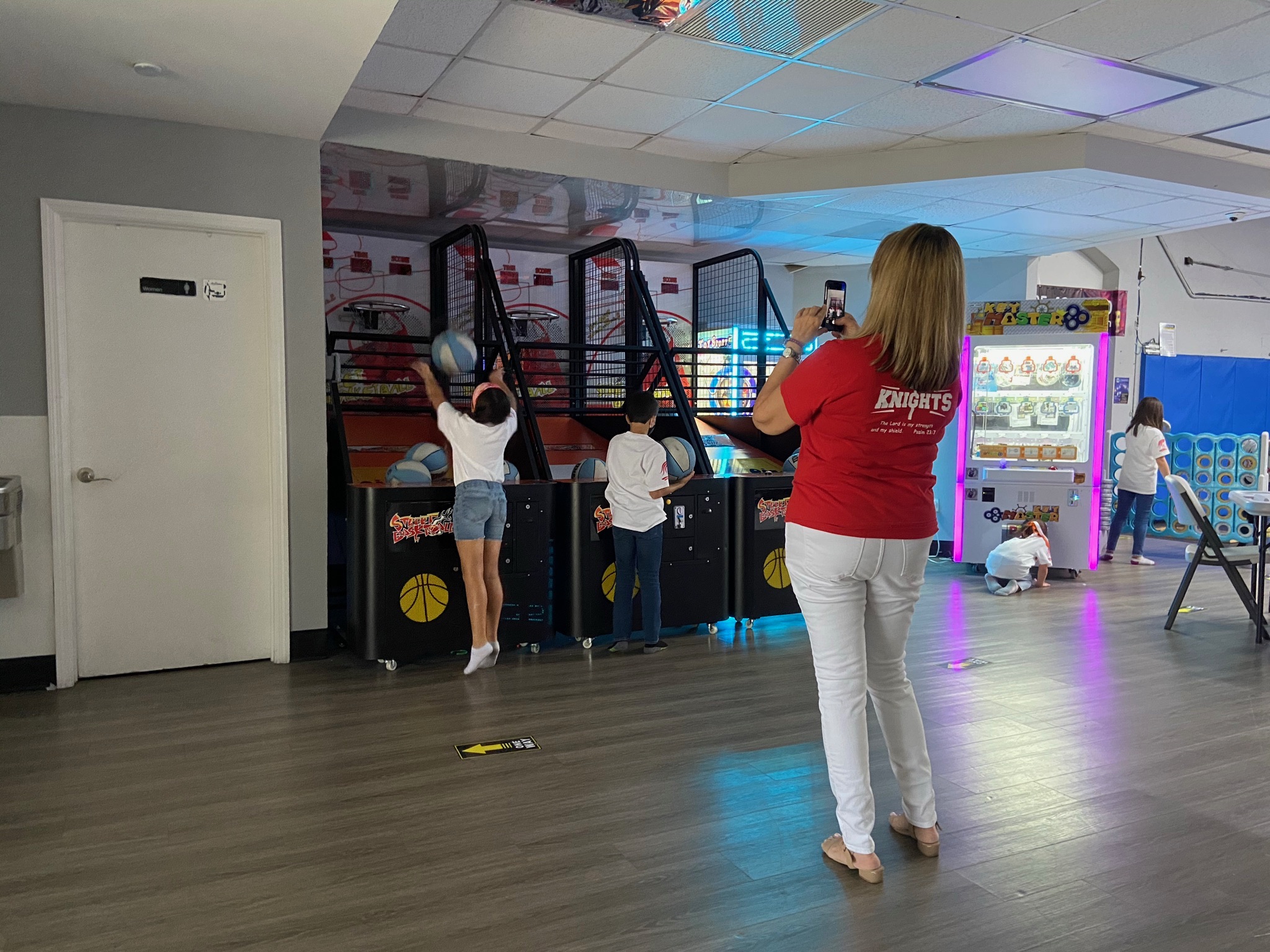 Kids playing basketball arcade shootout machines